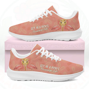 Coral pink cloud sneaker featuring tropical palm print, two flamingos in sunhats, and the text "GET IN A PICKLE, Flamingo style."